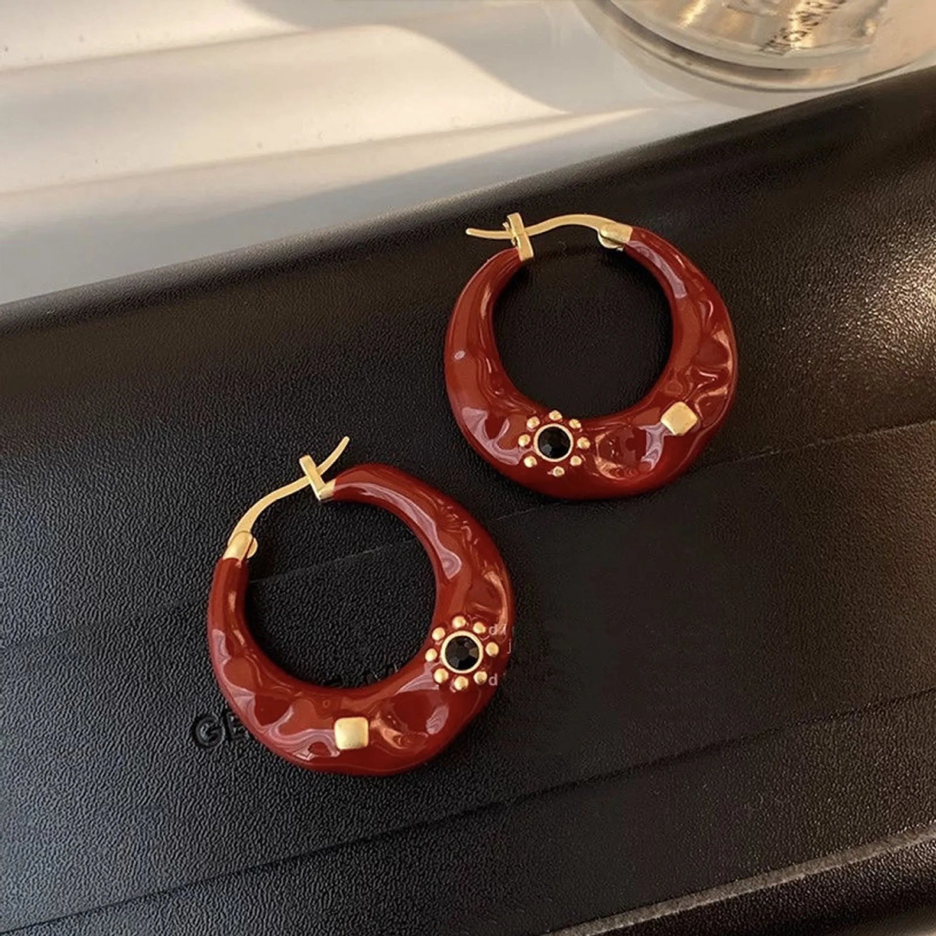 A pair of retro Hong Kong style alloy ear studs with rhinestone inlay, shown in black and red colour options.