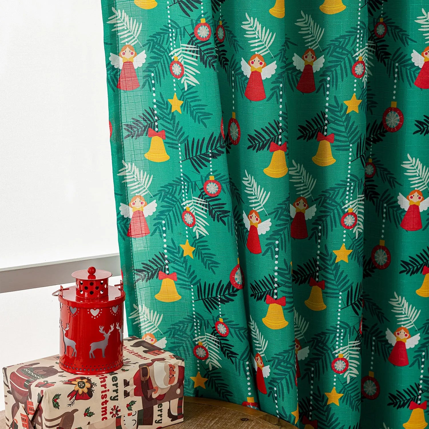 Christmas curtain with snowman and angel cartoon print in green, 1 metre length.