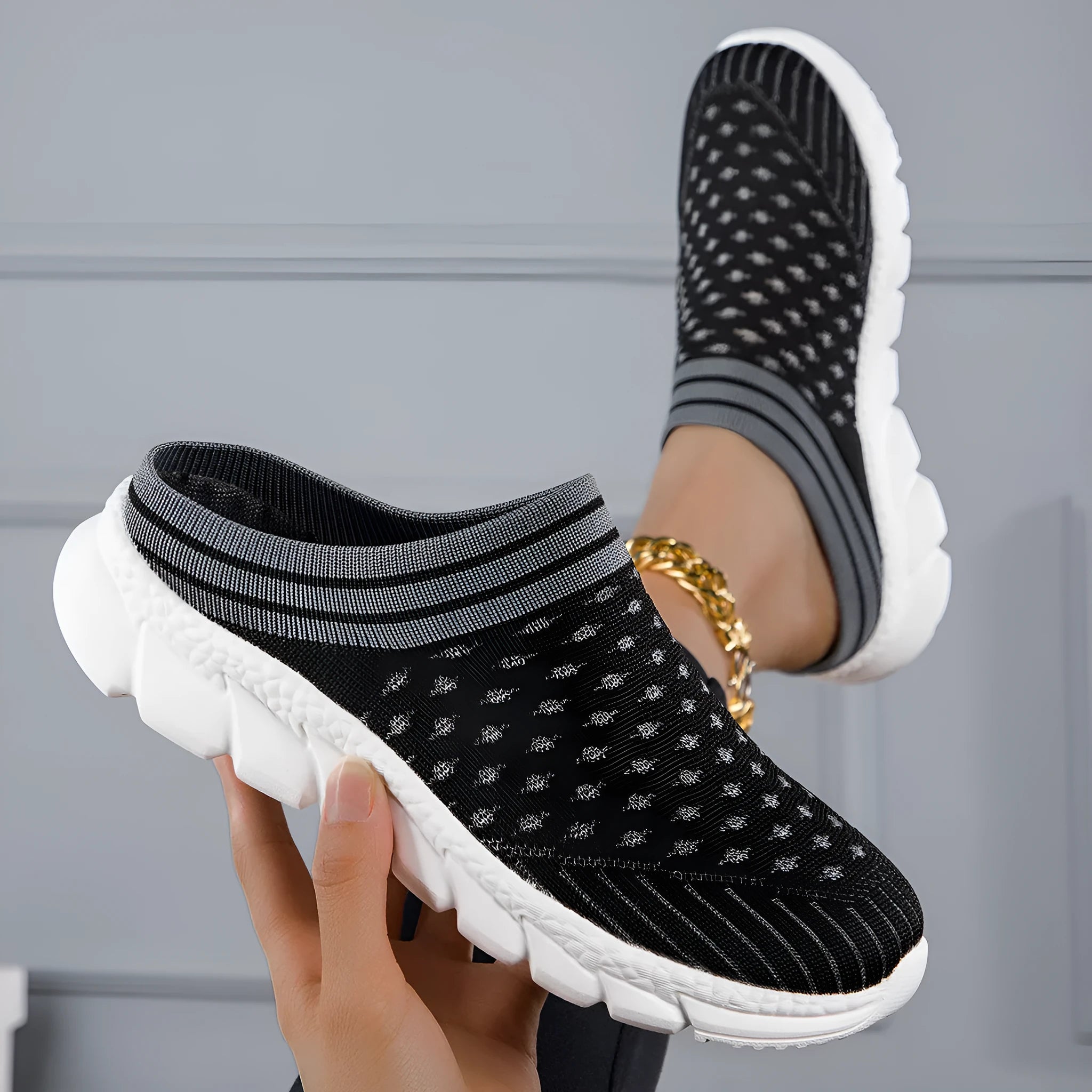 Women's black Flyknit casual shoes with striped pattern, hollowed-out design, and sewing lines on a lightweight sole.