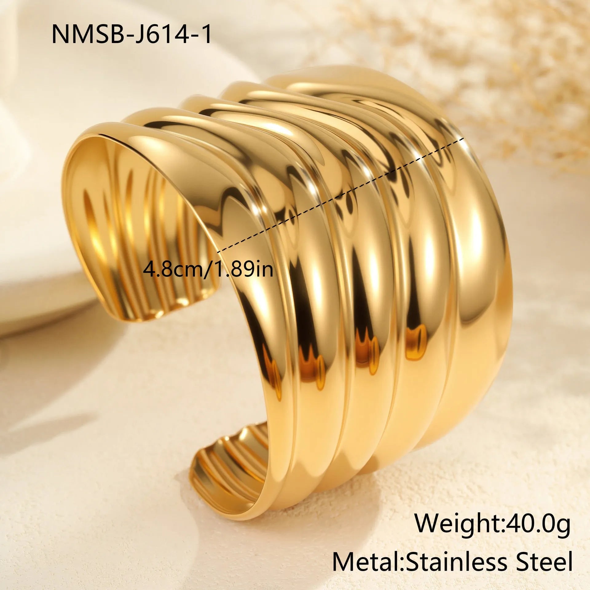 Women's wide stainless steel bracelet with 18K gold plating, geometric wave design, and niche opening closure.