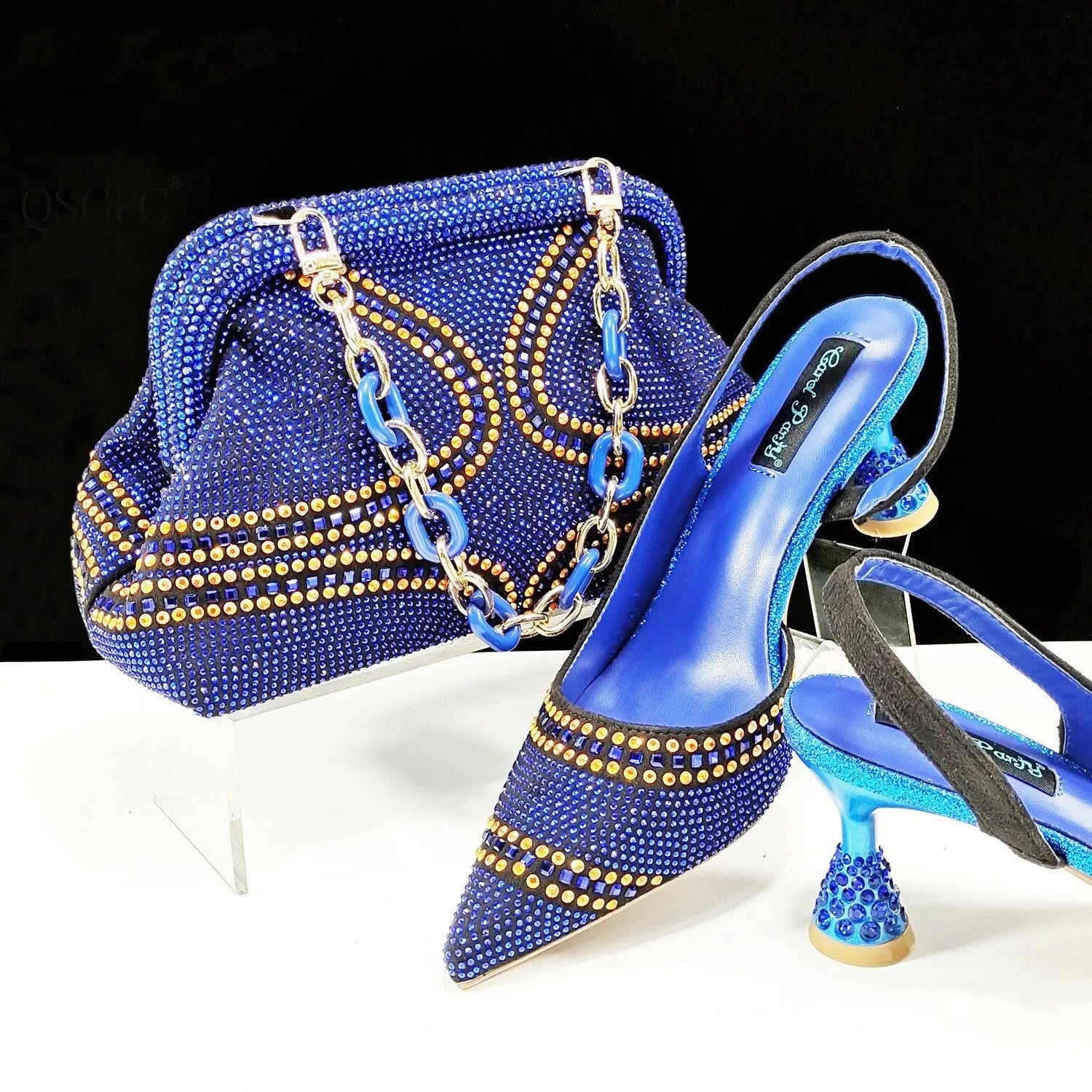 Women's pointed toe high heels with rhinestone details and matching small bag in synthetic leather