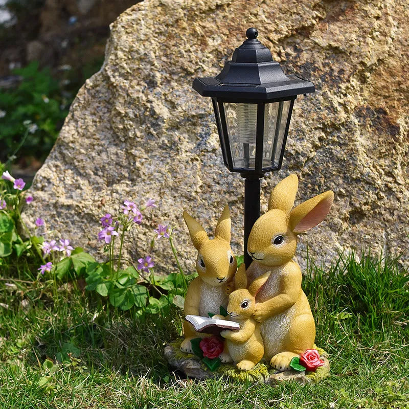 Solar hexagonal garden lamp with decorative resin figurine on plastic base for outdoor pathway lighting