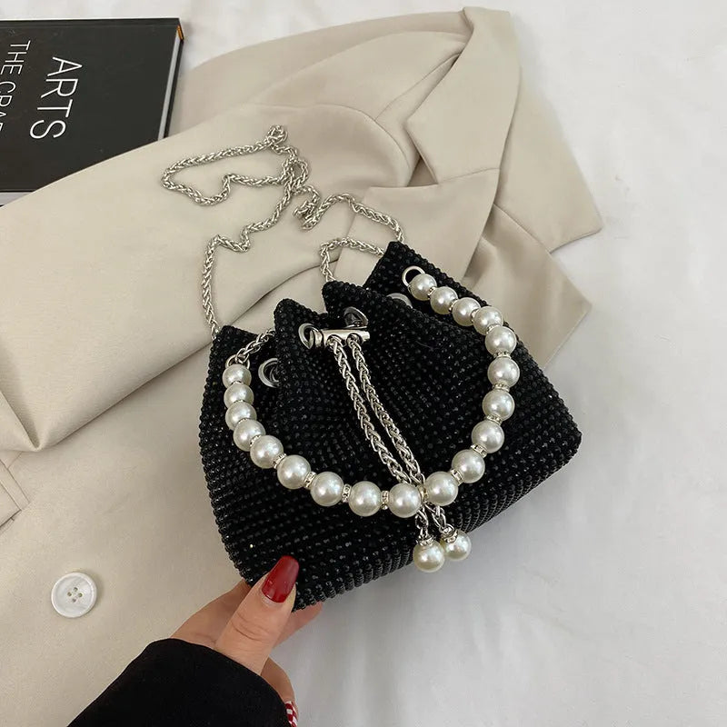 Diamond pattern women's crossbody bag in PU leather with metal chain strap, showing internal phone pocket and change purse.