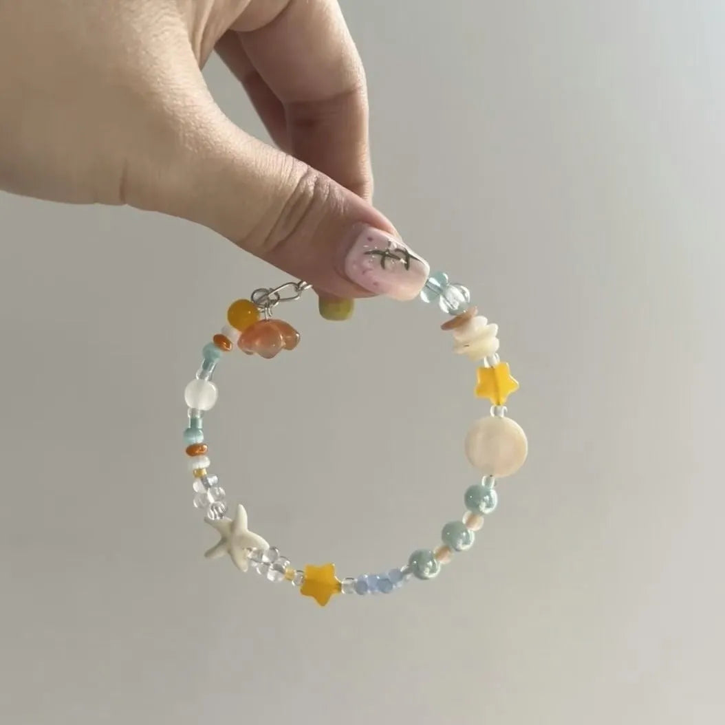 Orange sea colour diamond bracelet with round accents on adjustable alloy band