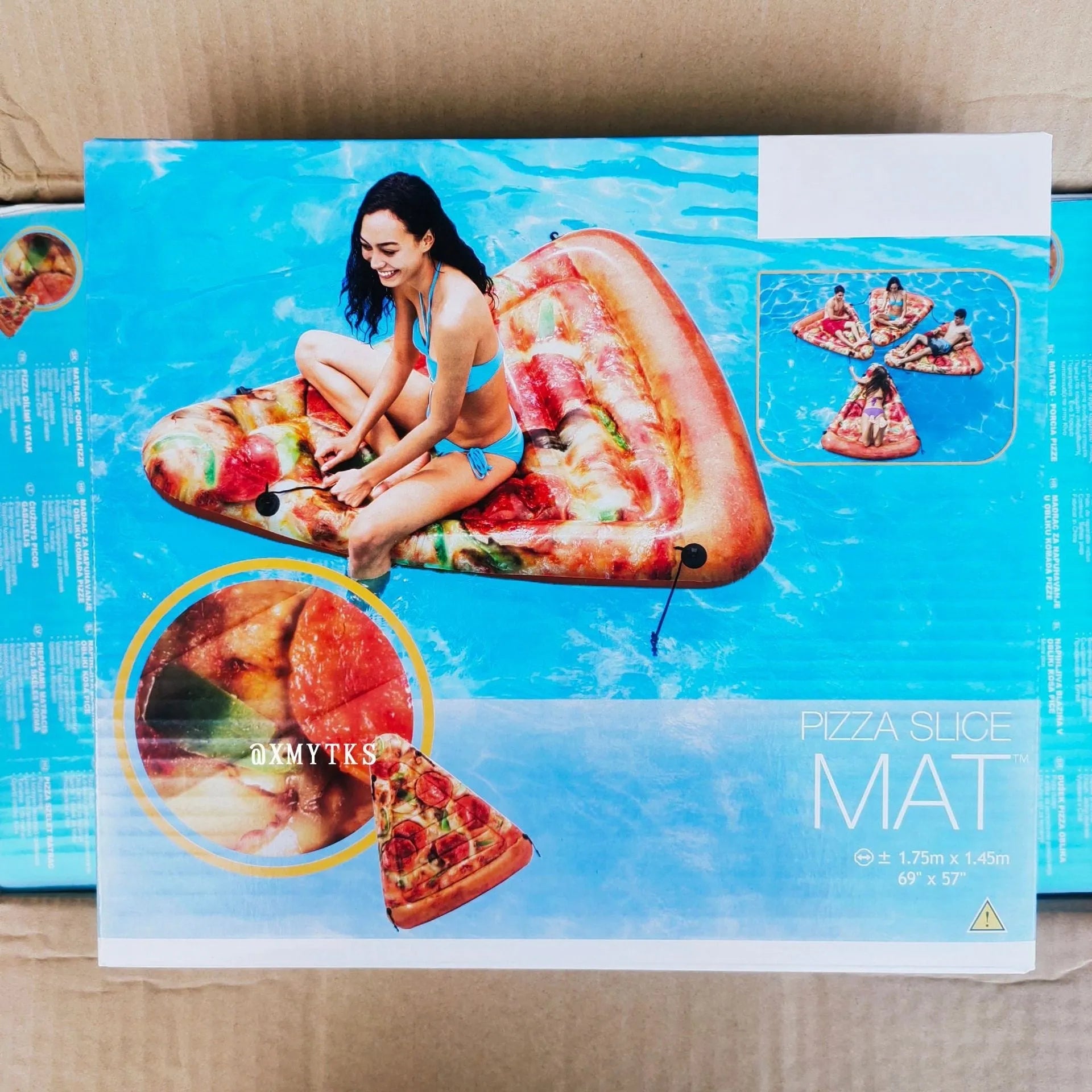 Inflatable pizza-themed surfboard lounger floating on water.