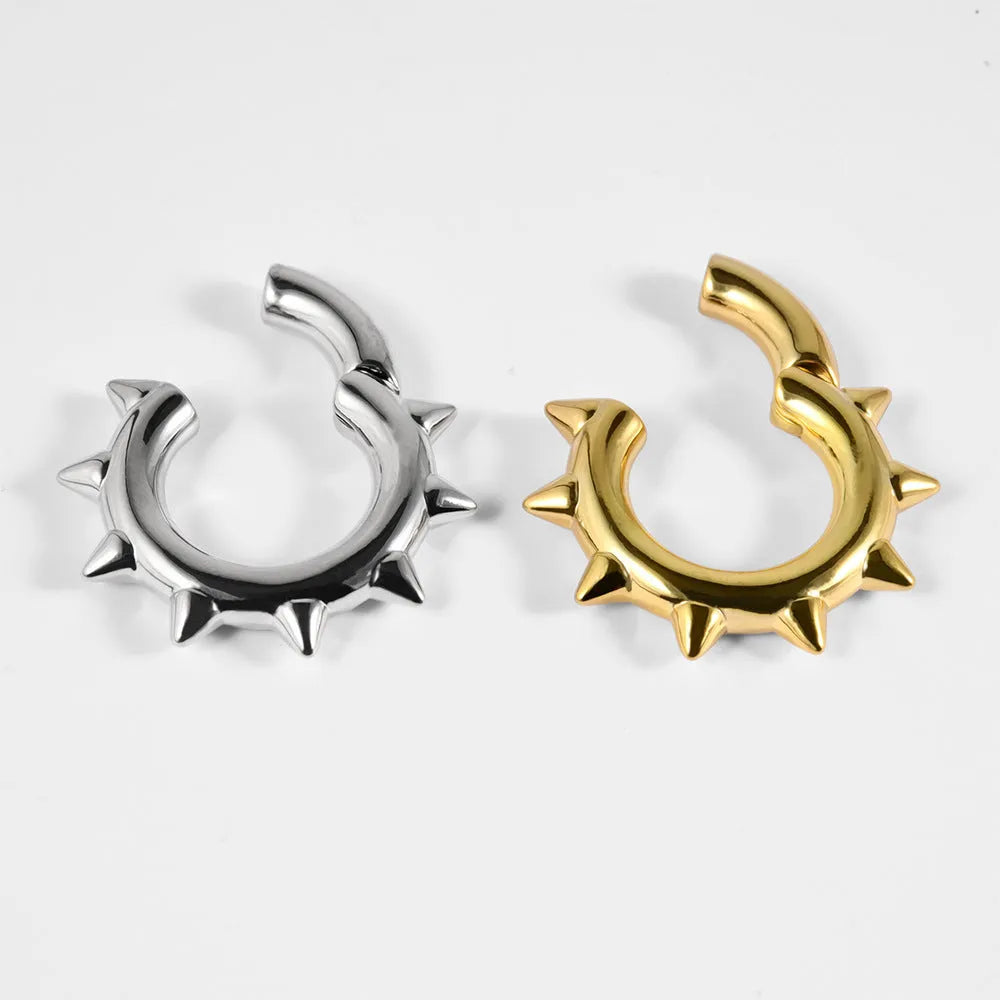 A pair of geometric cone and round shaped copper ear cuffs with magnetic clip-on fasteners.