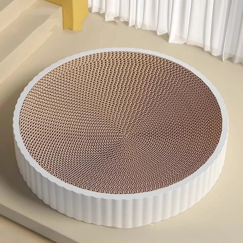 Green and white round cat scratching board with replaceable corrugated cardboard panels.