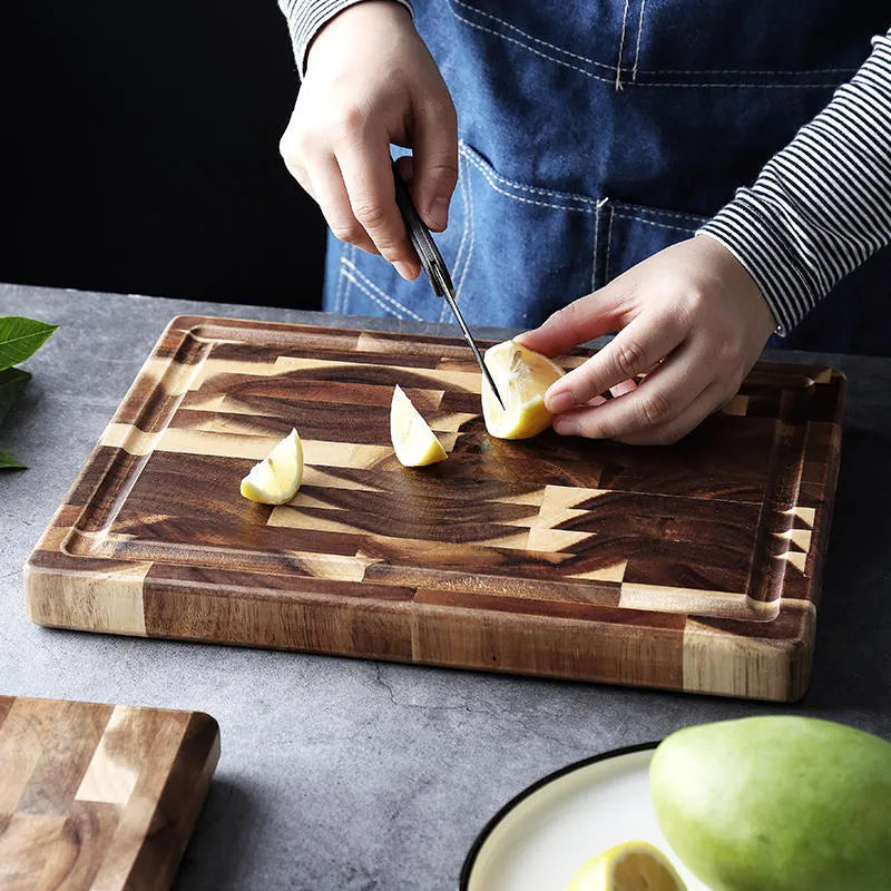 Brown solid acacia wood chopping board with 3cm thickness on a kitchen counter.