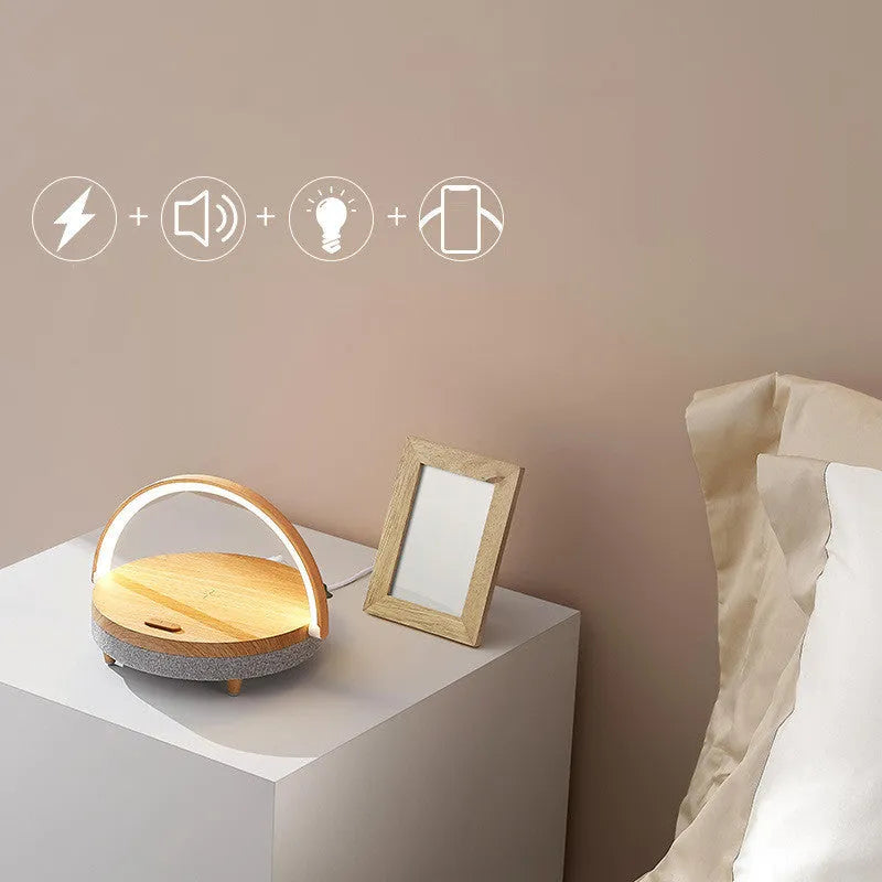 Wireless charging LED night light with Bluetooth speaker and phone holder in compact bedside design