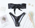 Black printed one-piece swimsuit with split tube top and backless design in nylon fabric