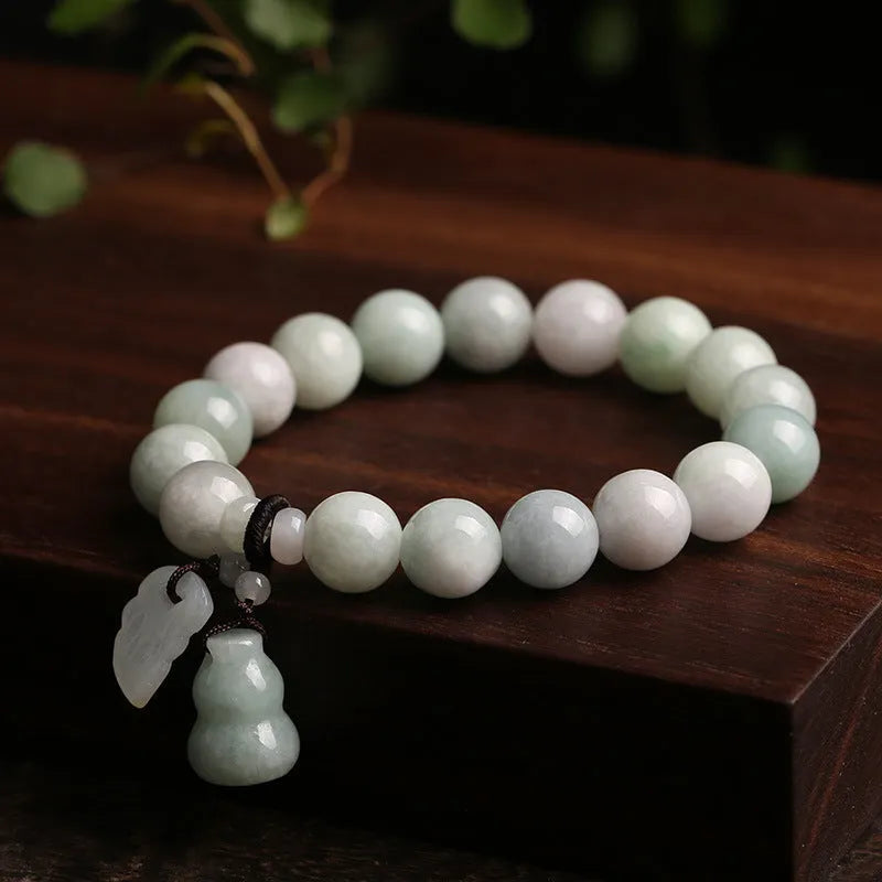 Natural green jade bracelet with geometric links and a carved Maitreya Buddha pendant.