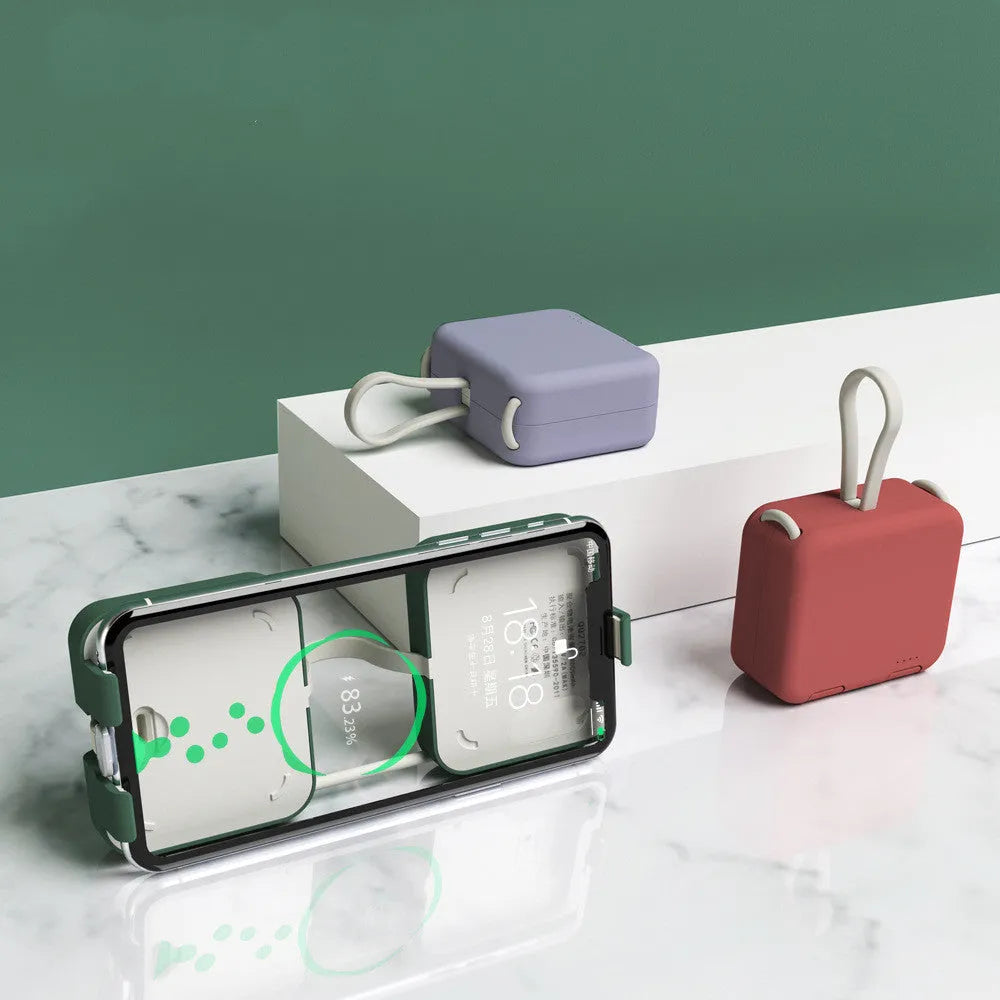 Handbag back clip power bank in blue, showing clip detail and phone standing in its holder mode.