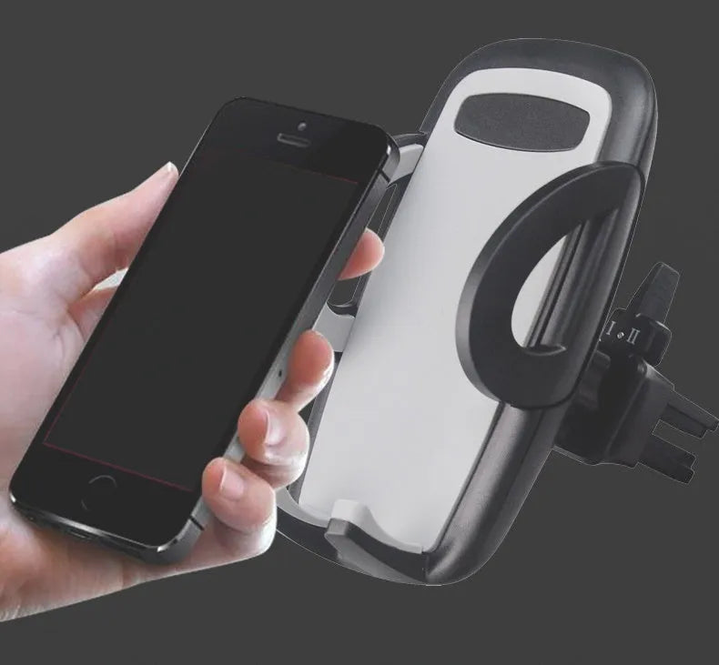 Black plastic car mobile phone holder mounted on air conditioning vent with adjustable arms gripping smartphone