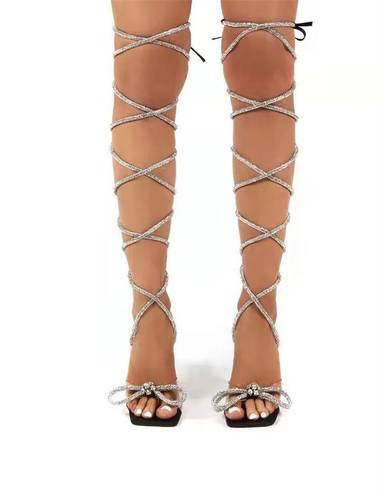 Plus size women's black strappy sandals with rhinestone Roman straps and a square toe