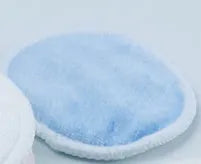 Set of red and blue velvet makeup remover pads next to a cotton mesh storage bag
