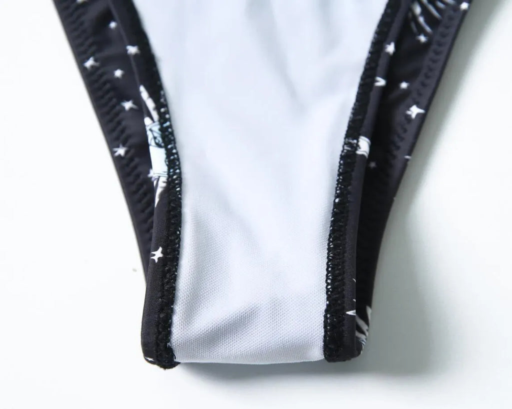 Black printed one-piece swimsuit with split tube top and backless design in nylon fabric
