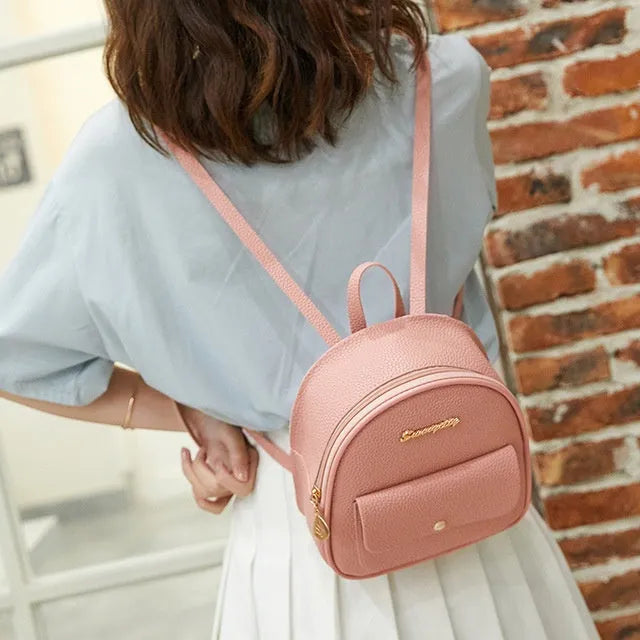 Women's small black PU leather backpack letter purse with shoulder strap measuring 18.5cm long