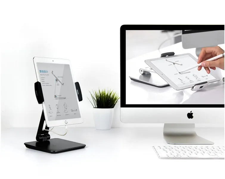 Folding aluminium desktop phone and tablet stand with 360-degree rotation on a wooden desk.