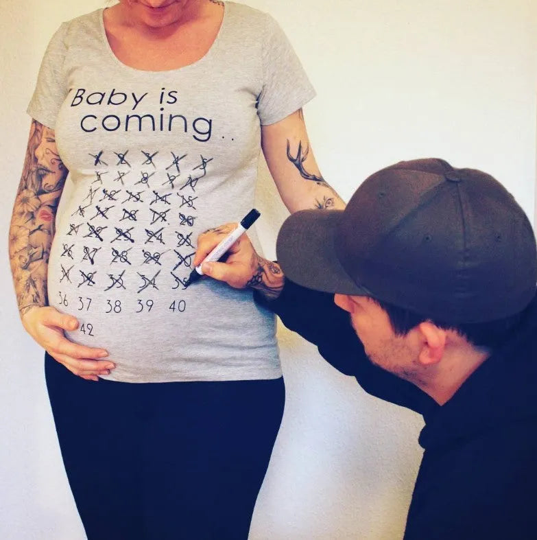 White cotton maternity t-shirt with hand print pattern, round collar, short sleeves on model