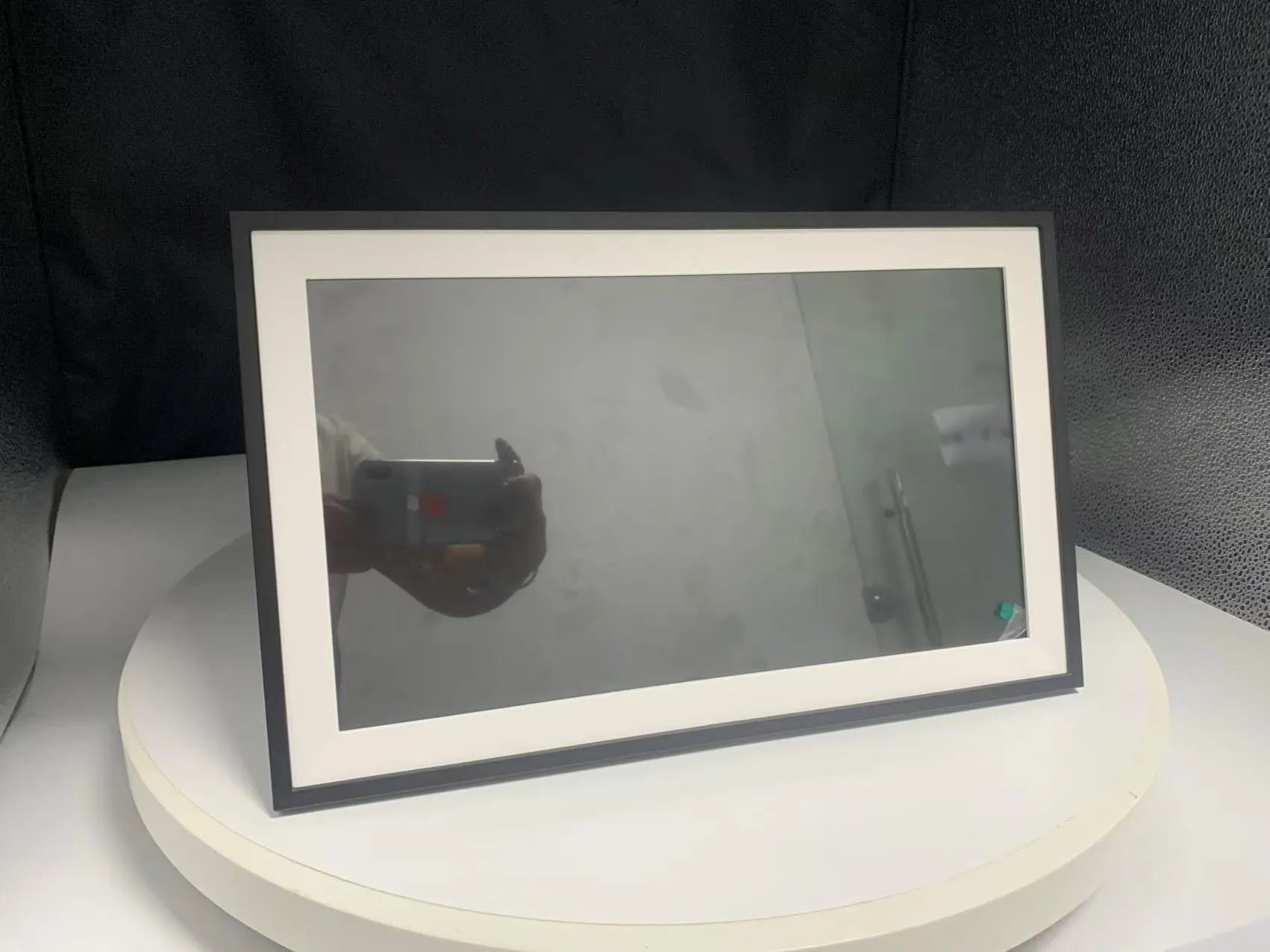 White smart digital photo frame with 15.6 inch screen displaying family photos