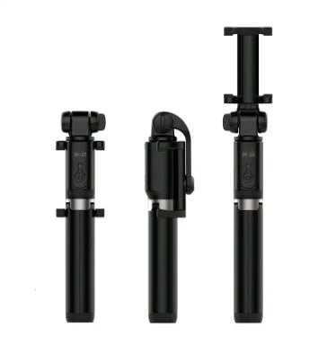 Aluminium Bluetooth selfie stick with tripod base and remote control next to a smartphone.