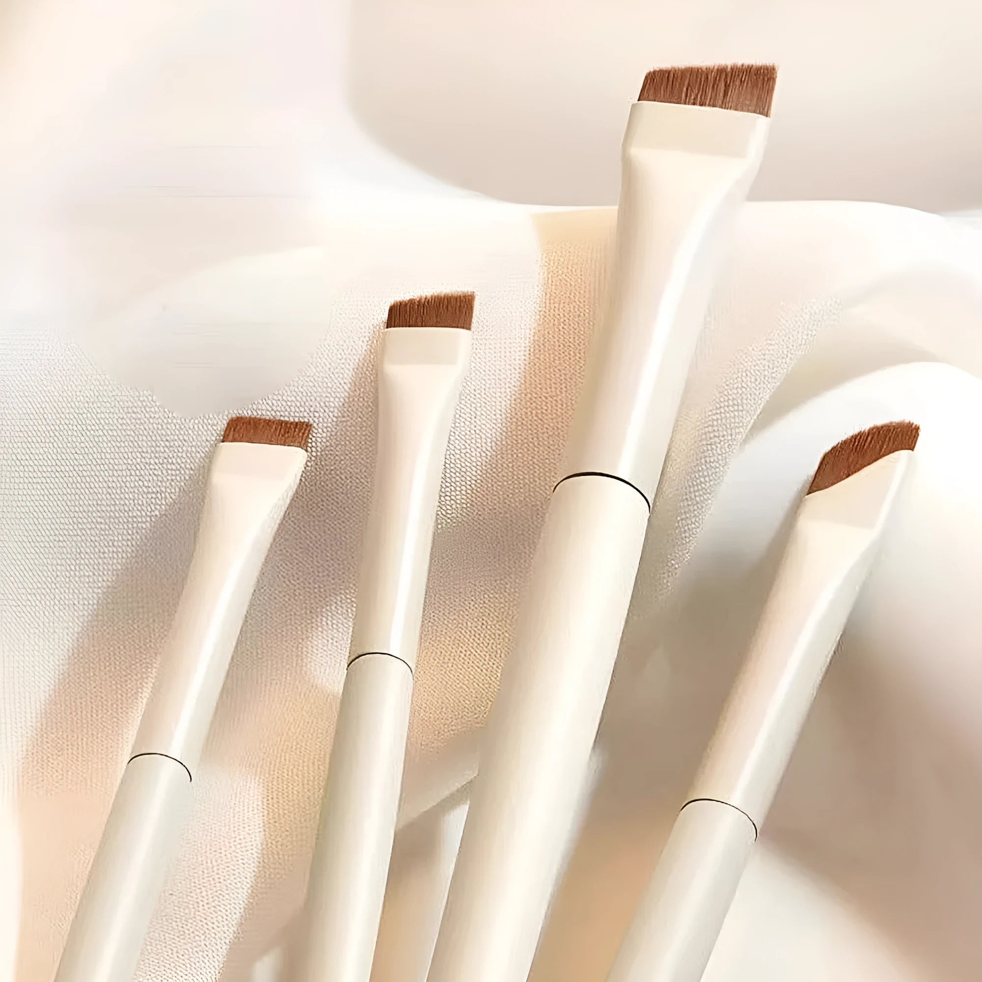Four angled eyeliner and brow brushes with ultra-thin precision tips for makeup application