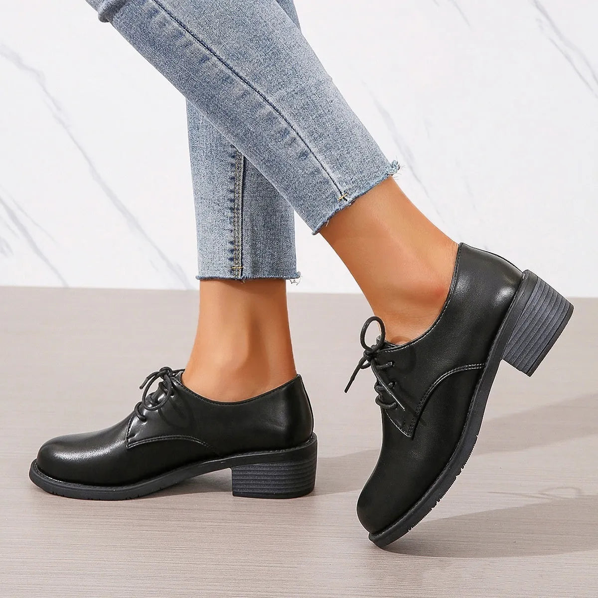 Black women's low-top slip-on work shoes with a chunky mid-heel and rounded toe.