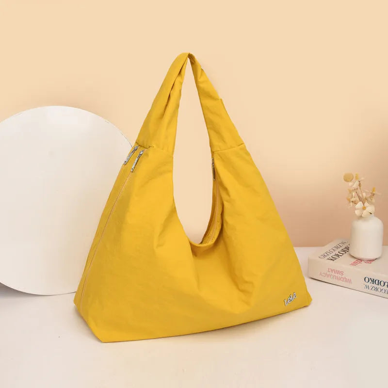 Nylon underarm bag with heart shape design in four colour options showing large capacity interior