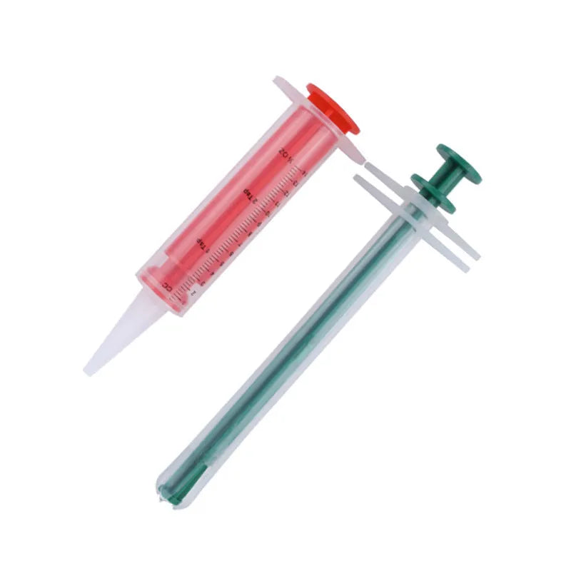 Two pet pill shooter syringes with soft silicone tips for administering tablets to cats and dogs