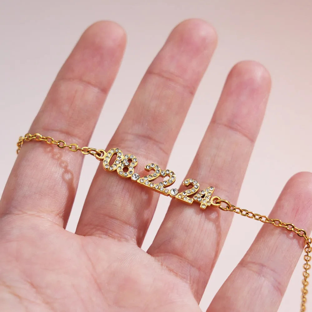 Stainless steel digital bracelet with crystal diamond accents on the numbers, shown in rose gold finish.
