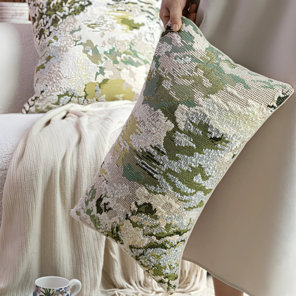 Antique green wool blend cushion with abstract spring flowers pattern, shown in square and lumbar sizes.