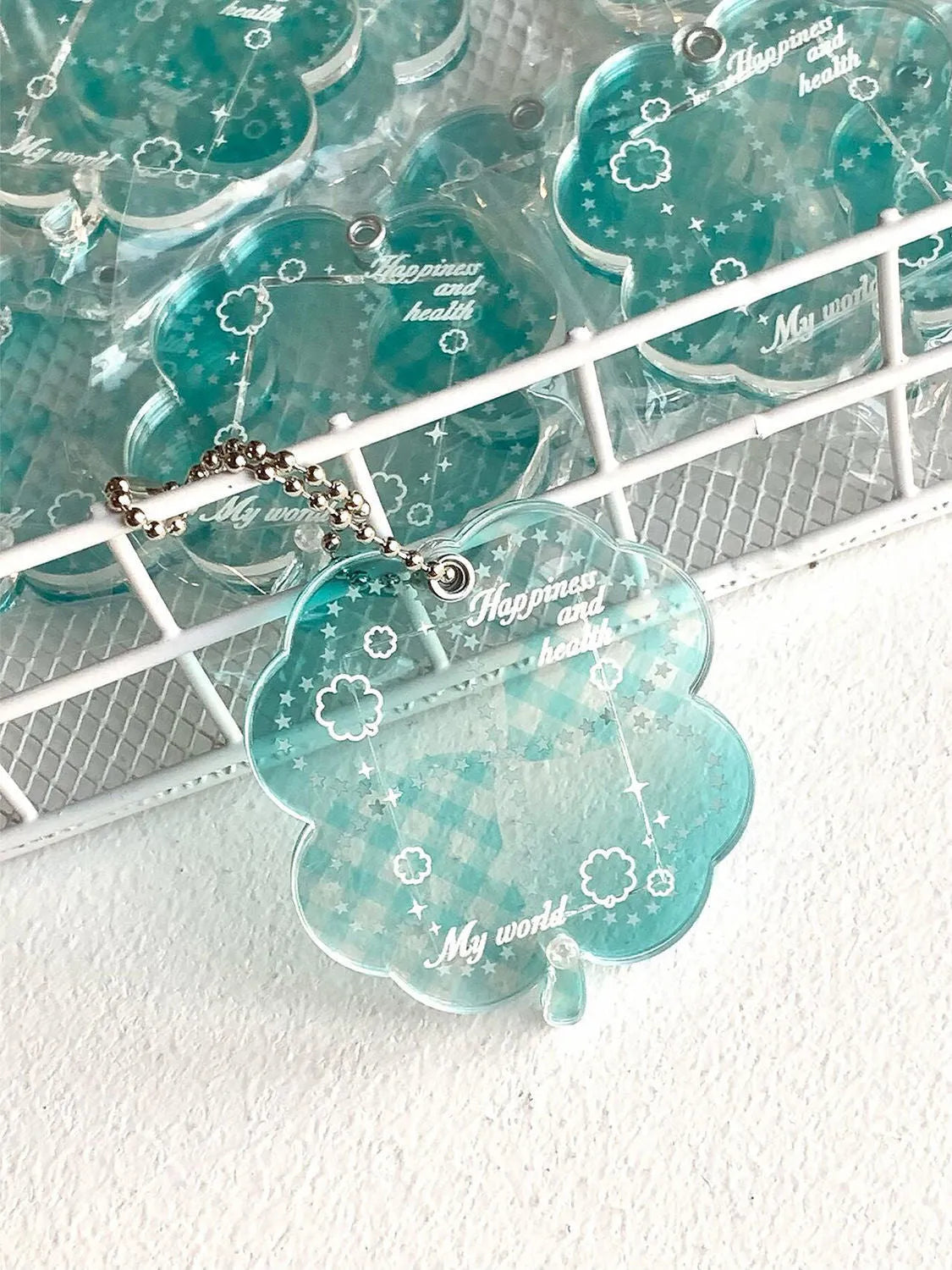 Acrylic four-leaf clover pendant keychain in blue, grass green, or mint green.