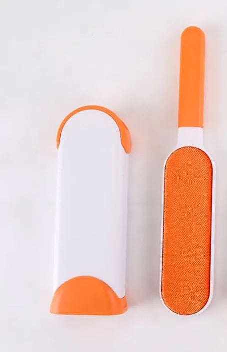 Blue reusable pet hair removal brush with a self-cleaning base, placed on a grey sofa.
