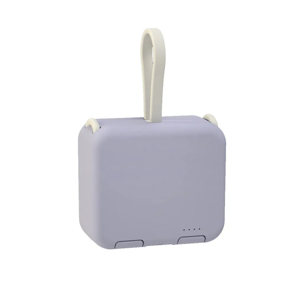 Handbag back clip power bank in blue, showing clip detail and phone standing in its holder mode.
