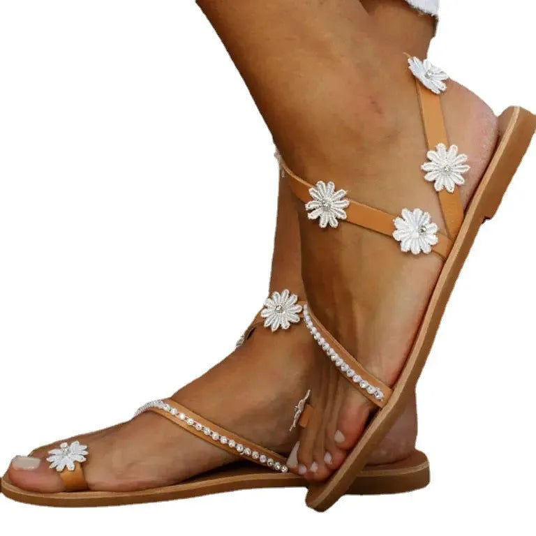 Brown women's Roman sandals with floral decoration and a flat rubber sole