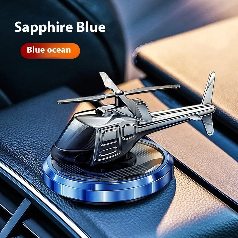 Silver metal solar helicopter car air freshener ornament rotating on dashboard
