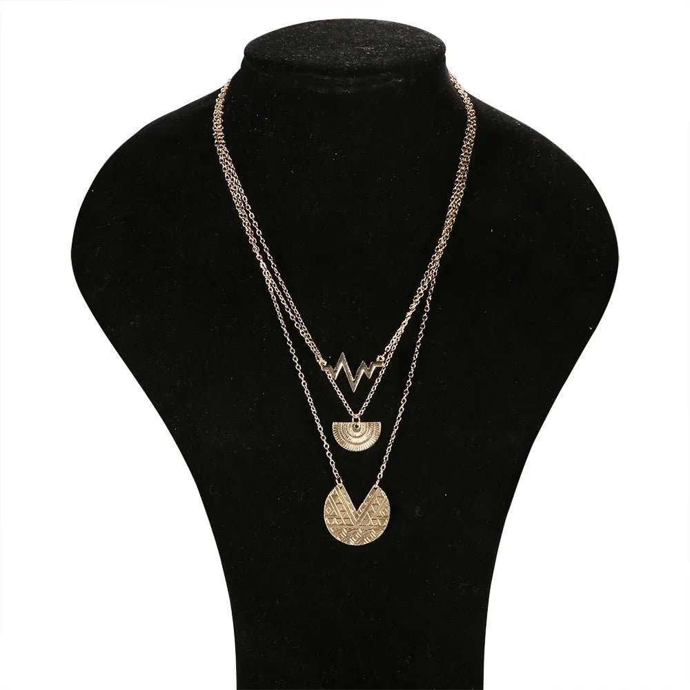 Gold multi-layer round alloy necklace with electroplated finish on white background