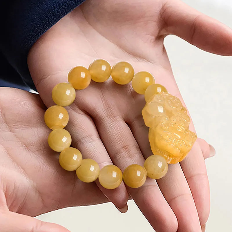 Golden thread jade bracelet with hand-carved money design showing two size options with jade beads