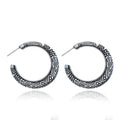 Vintage engraved bronze C-shaped alloy earrings showing curved silhouette and surface detailing