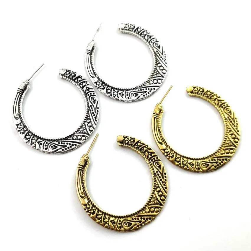 Vintage engraved bronze C-shaped alloy earrings showing curved silhouette and surface detailing