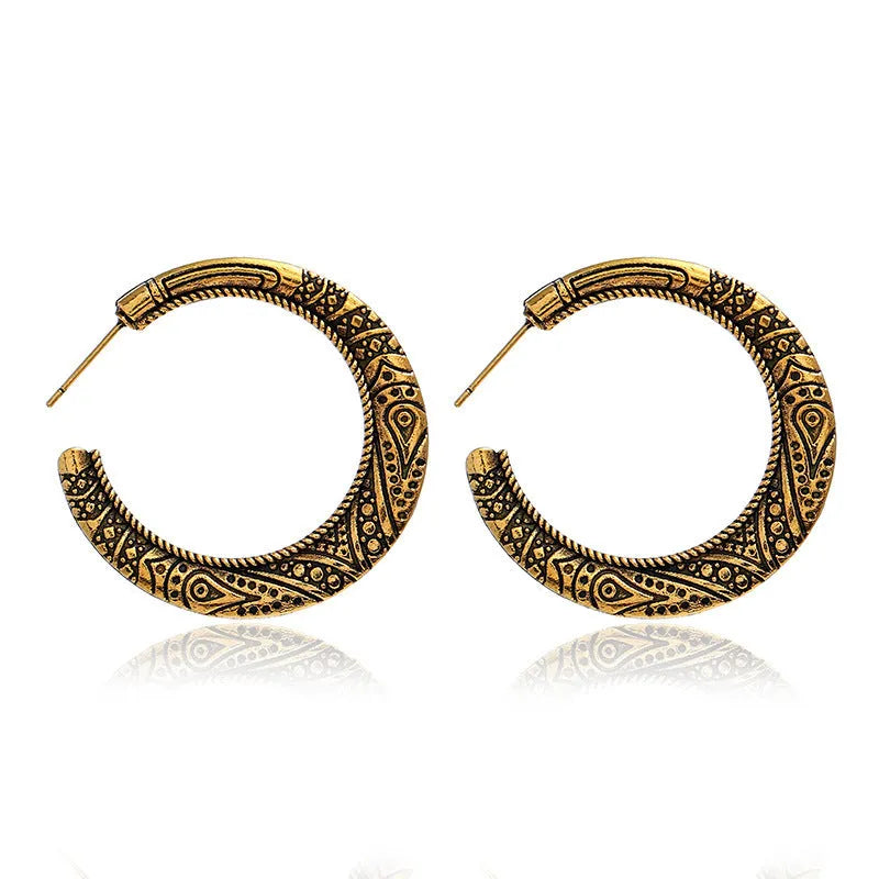 Vintage engraved bronze C-shaped alloy earrings showing curved silhouette and surface detailing