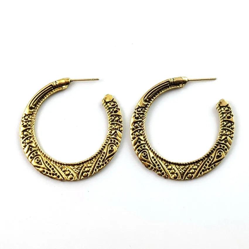 Vintage engraved bronze C-shaped alloy earrings showing curved silhouette and surface detailing