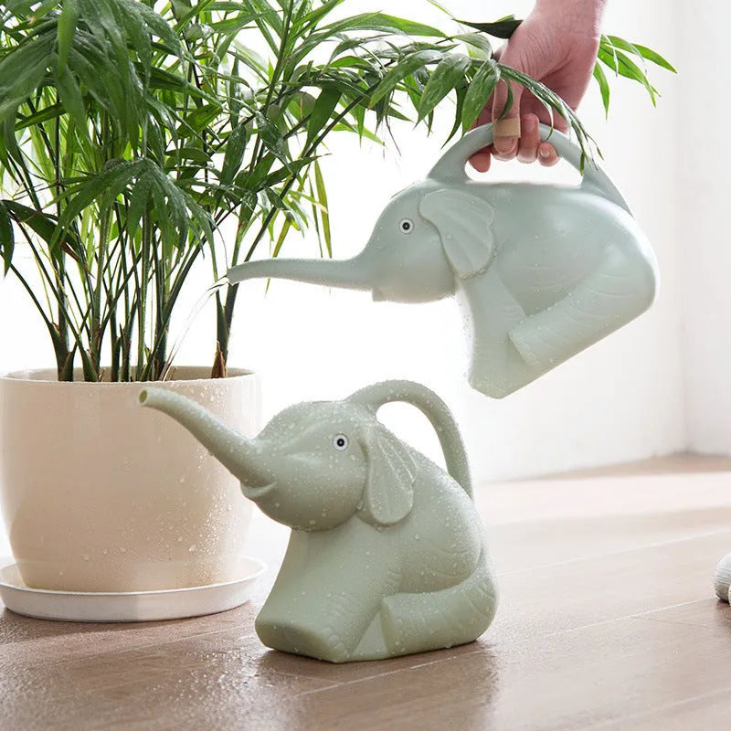 Pink elephant-shaped children's watering can with a long nozzle and baby bottle handle.
