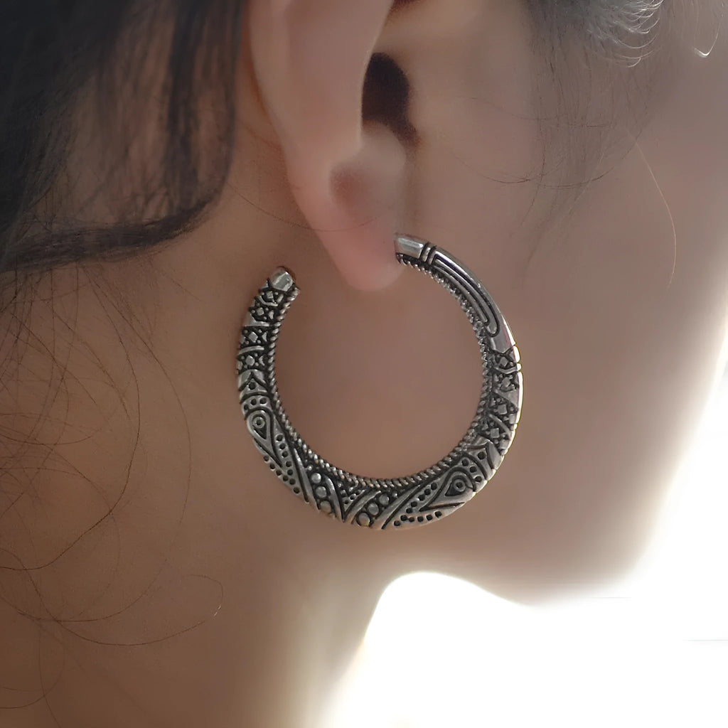 Vintage engraved bronze C-shaped alloy earrings showing curved silhouette and surface detailing