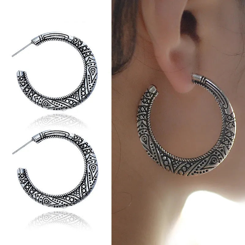 Vintage engraved bronze C-shaped alloy earrings showing curved silhouette and surface detailing