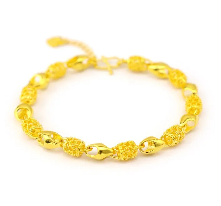 Gold-plated brass bracelet with thick vacuum gold coating on a white background