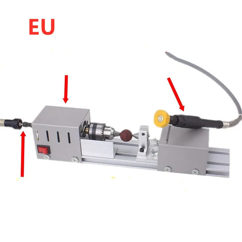 Mini silver metal manual woodworking lathe with carving knives on a workbench.