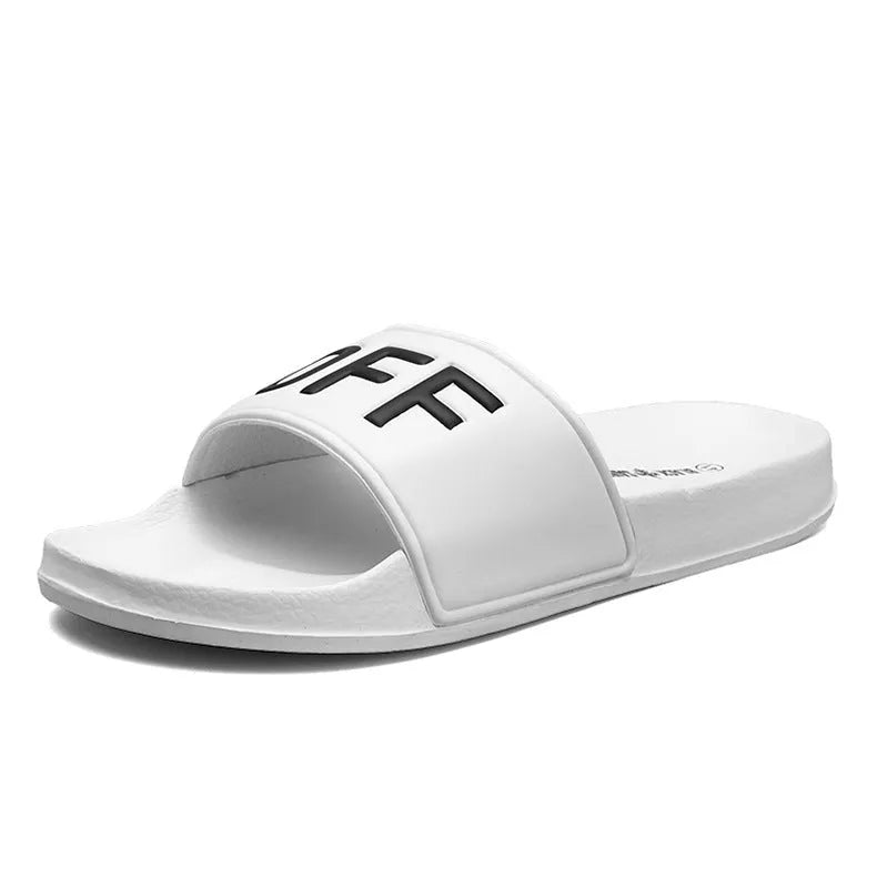 Men's black and white open-toe slippers with a textured rubber sole on a plain background