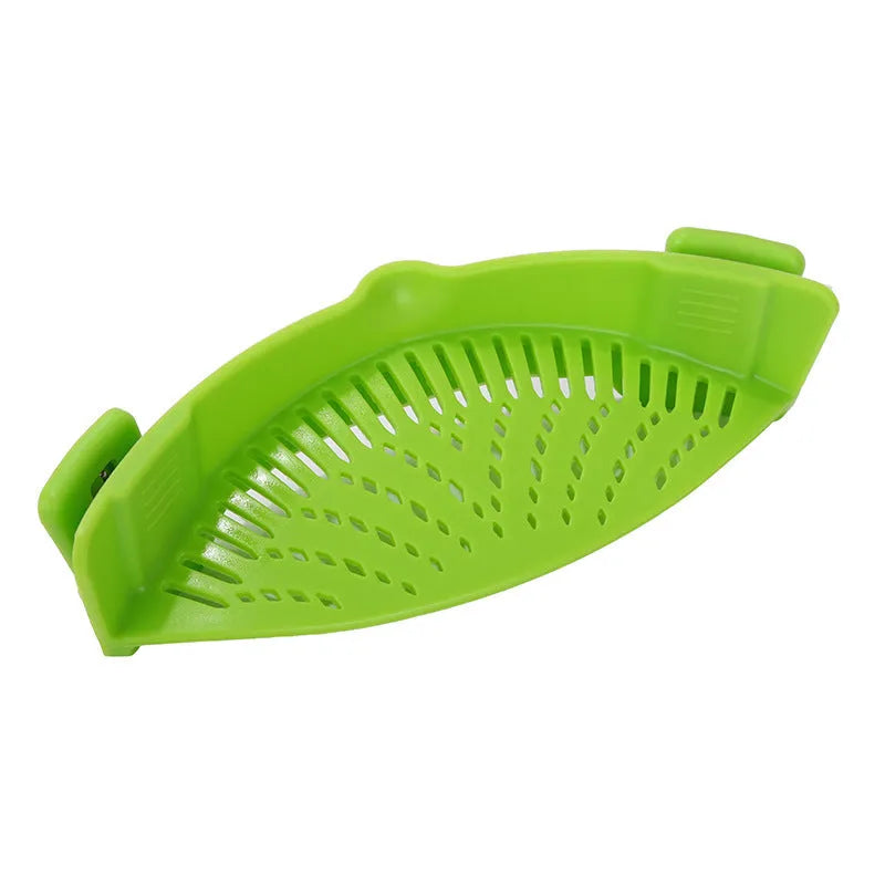 Silicone clip-on funnel strainer attached to a pot rim, showing hollow design and stainless steel buckle.