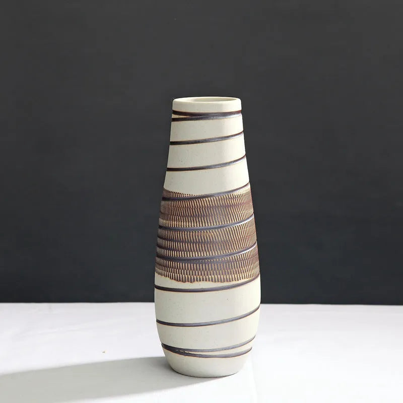 Three-piece ceramic vase set in low, medium, and tall sizes with vintage finish on a tabletop